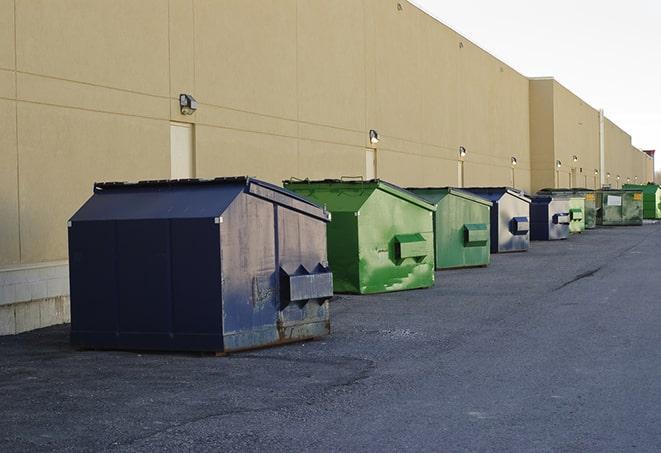 construction workers disposing of debris in large dumpsters in Berkley, MI